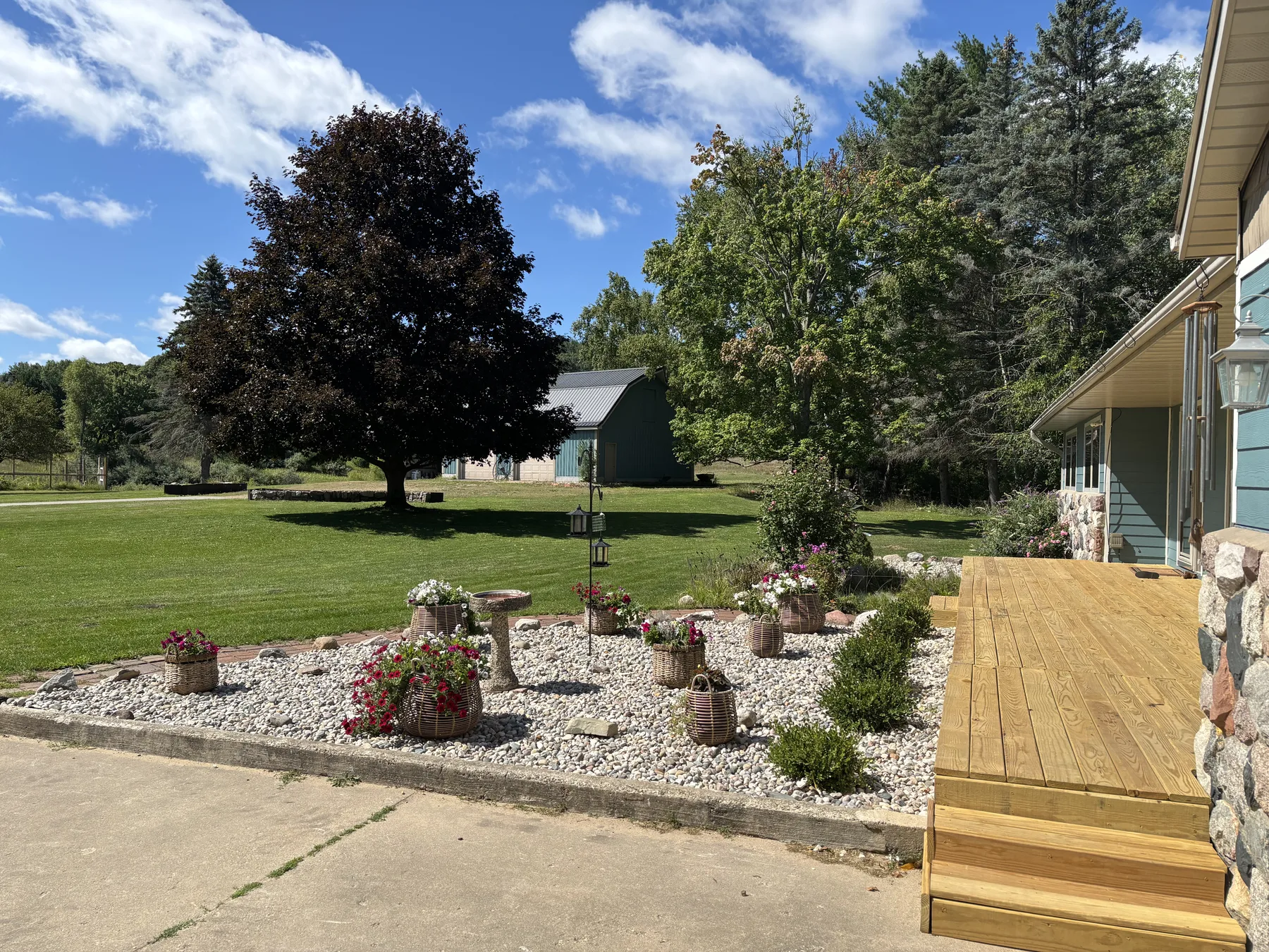 Updated river-stone landscaping and plantings beside the front entry