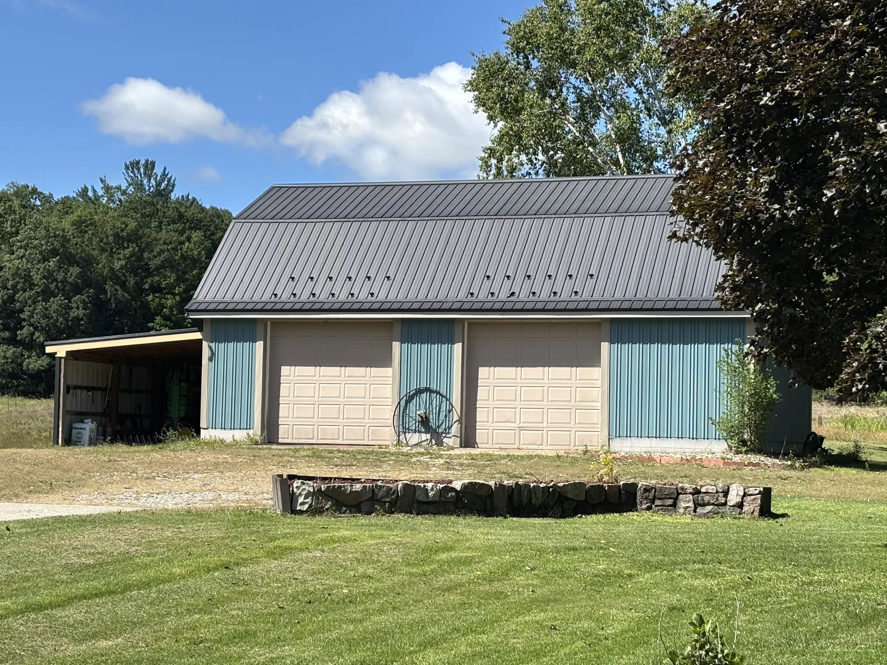 Freshly painted pole barn and workshop with attached lean-to