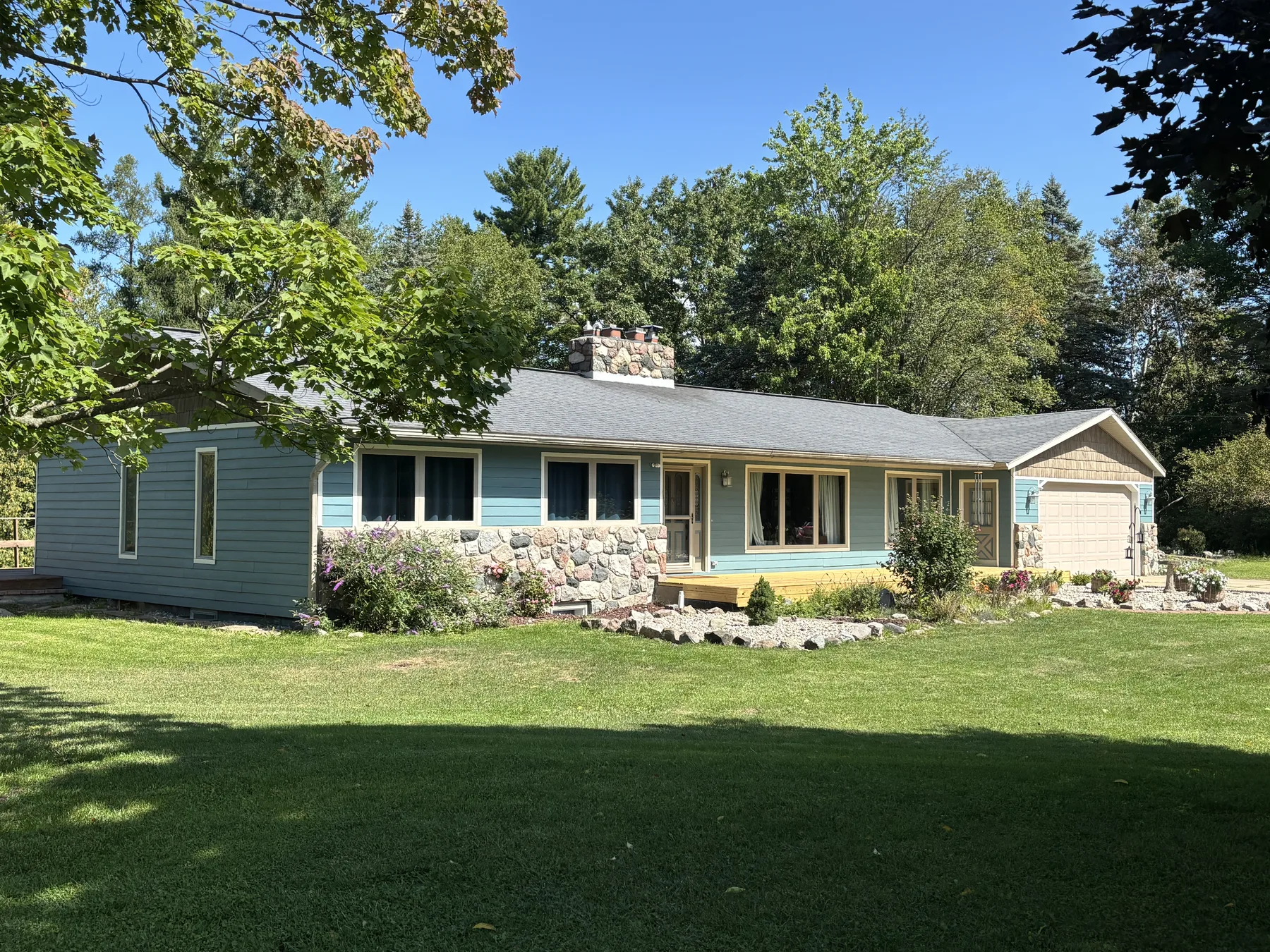 Updated Puddle Blue home exterior viewed across the shaded lawn